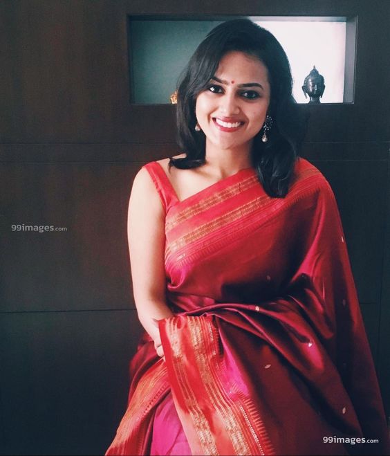 actress in red silk sari sleeveless