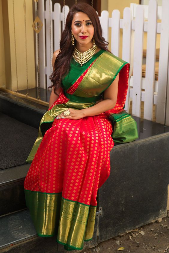 actress in red silk sari sleeveless